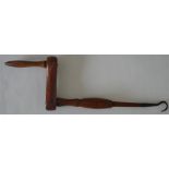 An unusual wooden handle mounted with a small cast