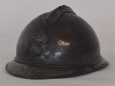 A French artillery helmet mounted with a grenade.