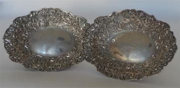 A pair of attractive embossed sweet dishes heavily
