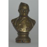 An unusual brass vesta in the form of a bust on pe