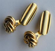 A pair of 14 carat knot decorated cuff links with