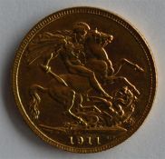 A 1911 full sovereign. Est. £180 - £220.