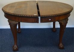 A mahogany oval extending table on ball and claw f