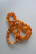A good heavy amber necklace with matching drop. Es