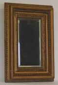 A rectangular gilt framed mirror with bevelled edg