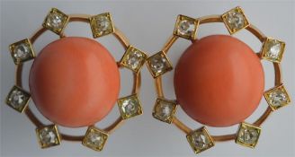 A large pair of circular coral and diamond cluster