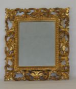 A well carved rectangular gilt mirror with leaf de