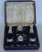 A good boxed six piece cruet with matching spoons
