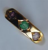 An emerald amethyst and pink stone ring in 18 cara