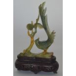 A small boxed hardstone figure of a bird on carved