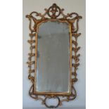 An attractive gilt mirror with scroll and swag dec