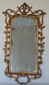 An attractive gilt mirror with scroll and swag dec