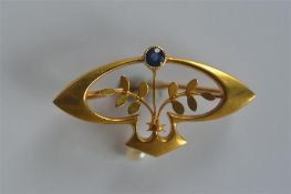 An Art Nouveau 15 carat sapphire and pearl flower