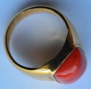 An 18 carat coral mounted single stone gypsy ring.
