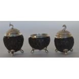 A Continental carved silver three piece cruet on b