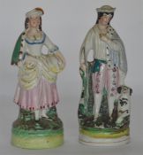 A pair of Staffordshire figures with green backgro