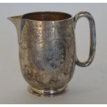 An attractive engraved cream jug decorated with fl