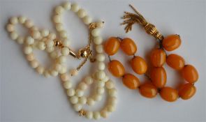 An unusual string of hard stone beads with gold dr