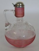 An attractive cranberry glass decanter with hinged