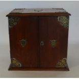 A large oak smokers cabinet with plated mounts and