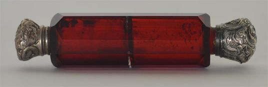 A small cranberry glass double ended scent bottle