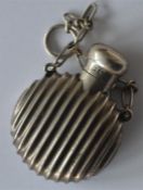 A small reeded scent bottle with hinged top and su
