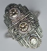 A good diamond three stone plaque ring in heavy wh