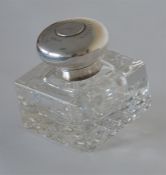 A hinged top glass inkwell inset with coin. London