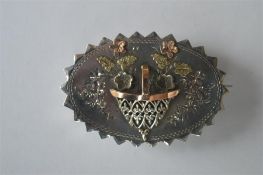 A gold and silver oval Victorian brooch of basket