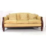 A William IV rosewood and upholstered three seater sofa with scrolled arms on turned feet