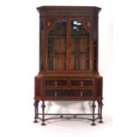 An Edwardian mahogany, strung and inlaid break-front display cabinet on stand,