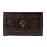 A 17th century and later oak carved and panelled coffer on square straight stiles, l.