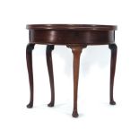 A George I mahogany games table, the fold-over surface concealing a storage compartment,