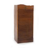 A 1920/30's beech cabinet, the tambour door closing drawers, on a plinth base, h.