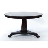 An early 19th century rosewood circular supper table on an octagonal column,