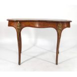 A Victorian walnut and gilt metal mounted writing table of kidney form,