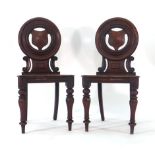 A pair of Victorian mahogany hall chairs,