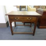 An 18th century oak side table with a single frieze drawer over a shaped apron on square straight