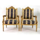 A pair of French Louis XVI-type giltwood and upholstered armchairs on arrow legs