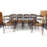 A set of ten Regency rosewood and brass marquetry dining chairs with cane seats on sabre legs,