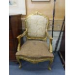 A pair of French Louis XVI-type giltwood and partially upholstered salon armchairs on cabriole legs