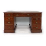 A late 19th/early 20th century walnut twin pedestal desk,