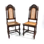 A pair of 17th century-style oak and bergere hall chairs on turned legs joined by stretchers