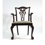 A set of four Chippendale-type mahogany and upholstered dining chairs on cabriole legs with ball