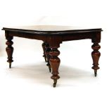 A Victorian mahogany extending dining table, with three fitted leaves,