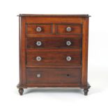 An early 20th century mahogany miniature chest of drawers on bun feet, h.