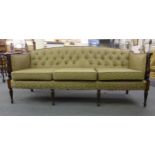 A Regency and later mahogany and button upholstered three seater settee on turned and reeded legs