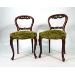 A set of eight Victorian mahogany and upholstered balloon back dining chairs on cabriole legs