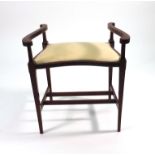 An Edwardian mahogany and strung stool of bowed form on square tapering legs with block feet