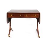 A Regency rosewood, walnut crossbanded and strung sofa table with two frieze drawers on sabre legs,